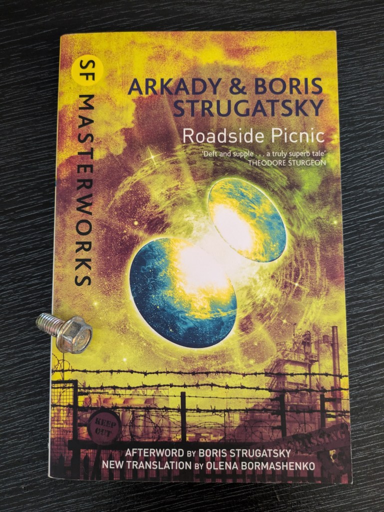 Paperback copy of the SF Masterworks edition of 'Roadside Picnic' by Arkady and Boris Strugatsky. There is a metal bolt on top of the cover.