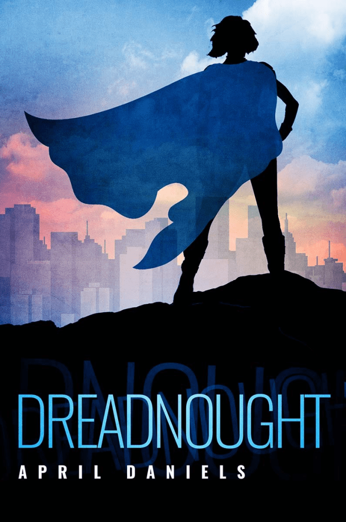 The cover of 'Dreadnaught' by April Daniels. he cover depicts the silhouette of a young girl in a blue cape standing on a mountain overlooking a city skyline. he sky is blue and pink.
